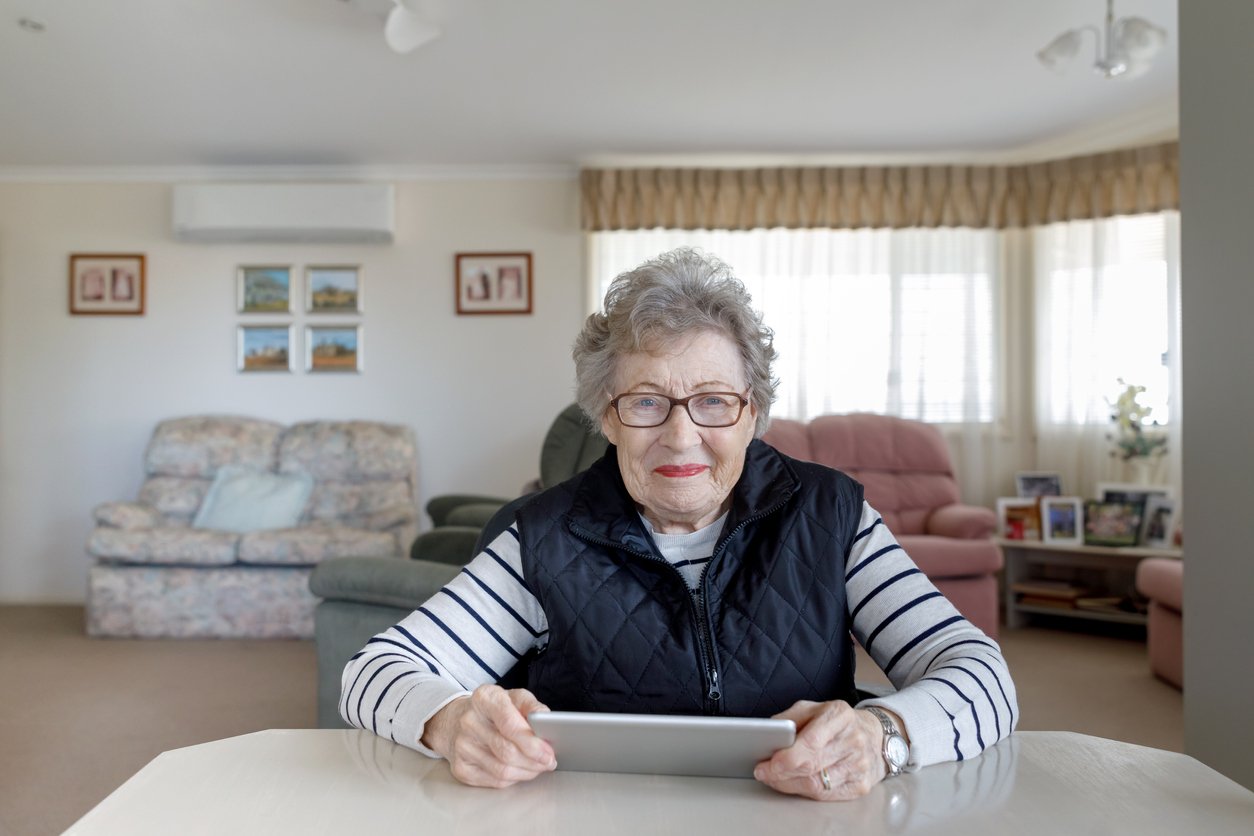 Senior woman using tablet to stay connected during time spent sheltering in place during the pandemic
