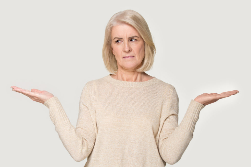 Senior woman shrugging to signify confusion around senior living 
