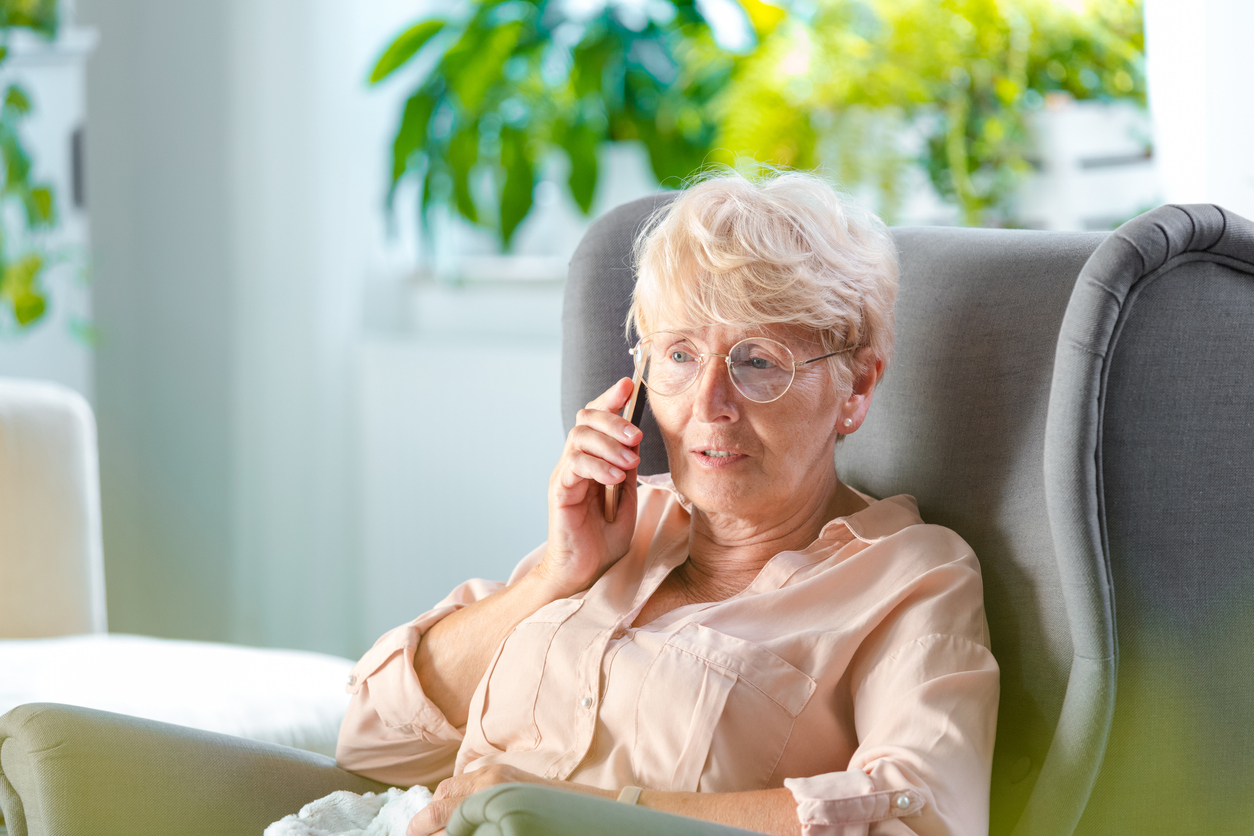 Senior woman on phone calling to ask questions about moving to a senior living community during the COVID-19 pandemic